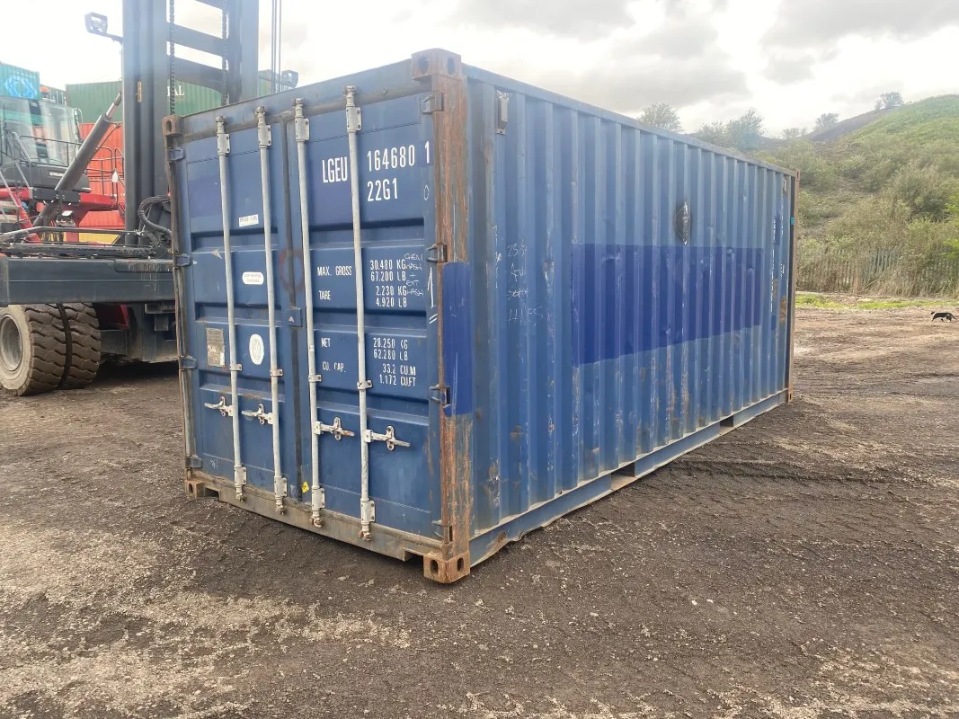 Used blue shipping container showing minor cosmetic wear but structurally sound